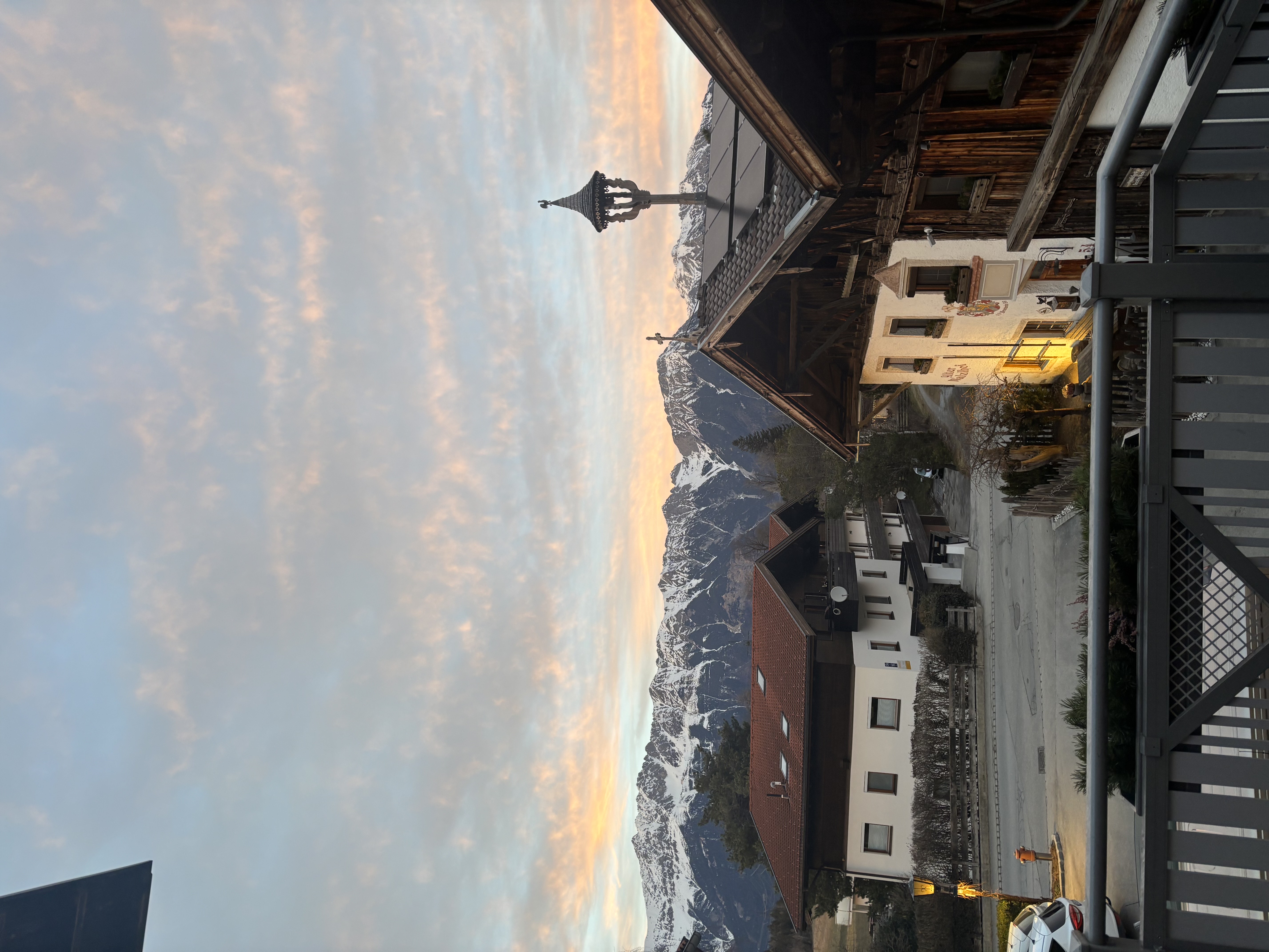 Beautiful Alpine village at sunset with snow-capped mountains - the scenic backdrop of international luge competitions