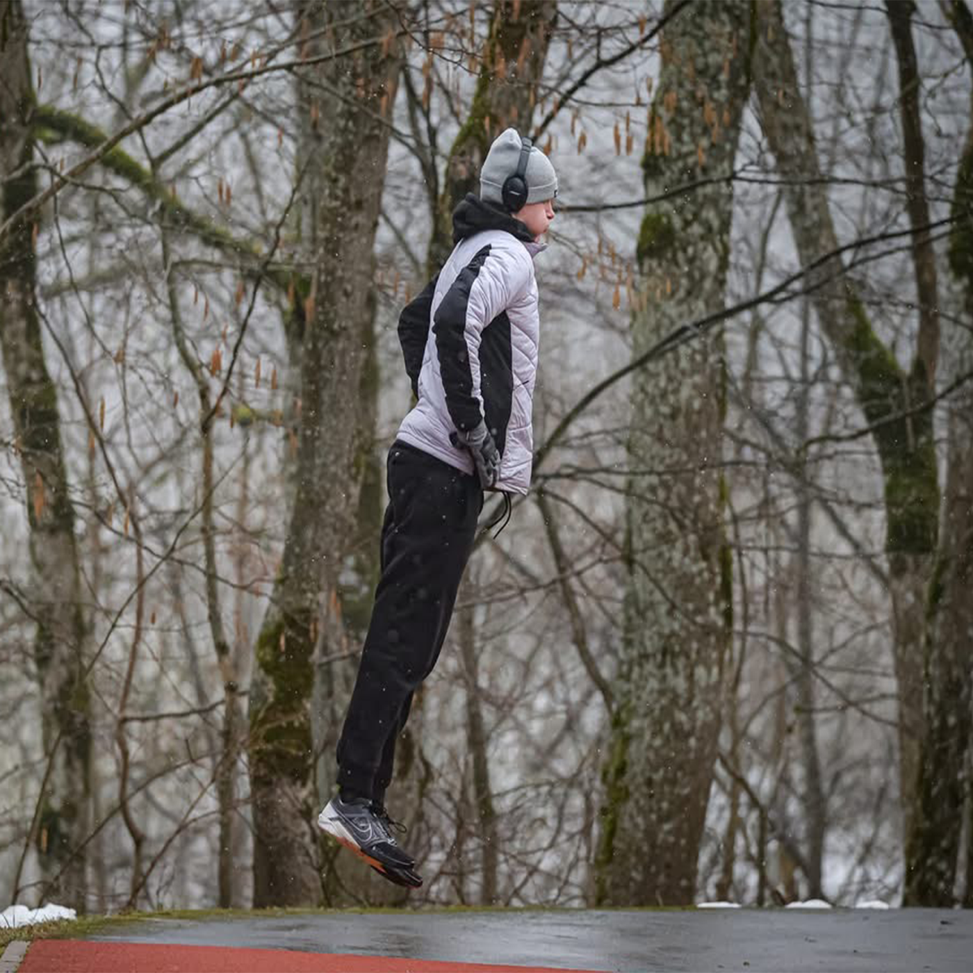 Logan performing plyometric training exercises in winter conditions, demonstrating the physical preparation required for luge
